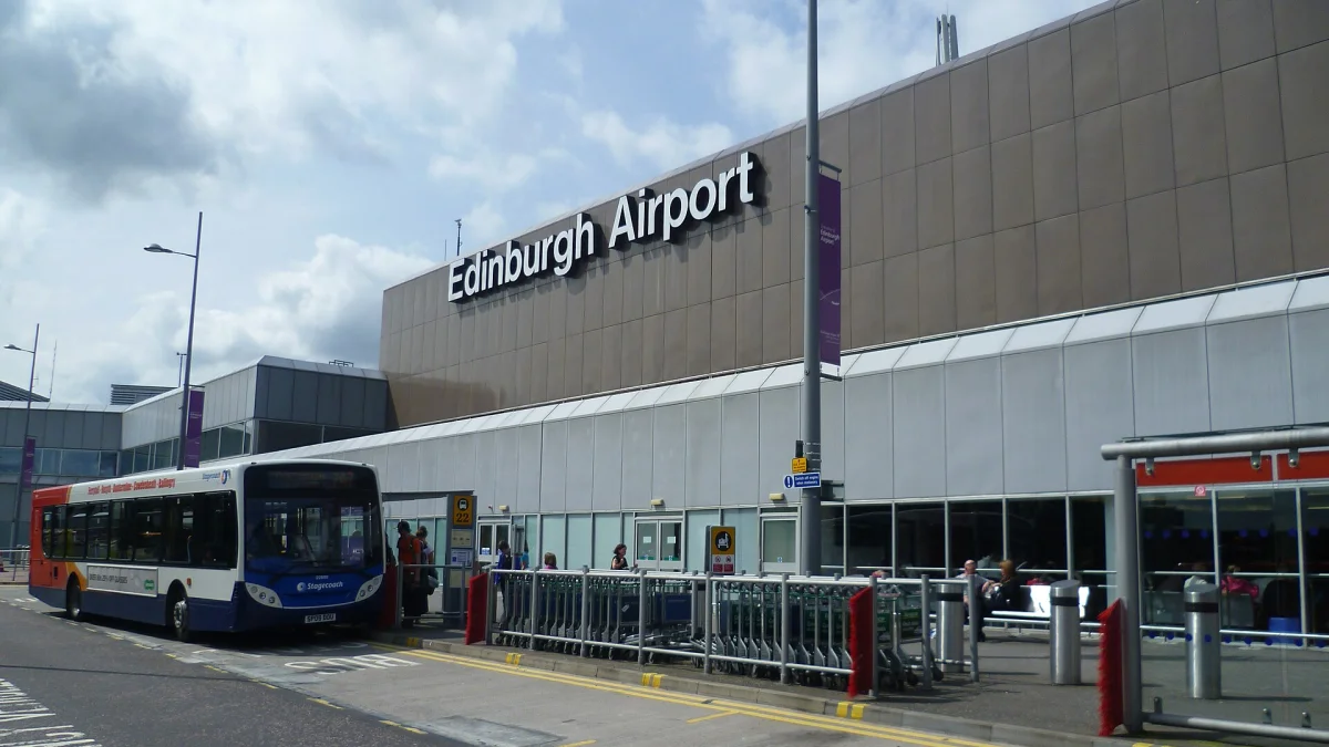 Cars and taxis at a UK airport terminal drop-off