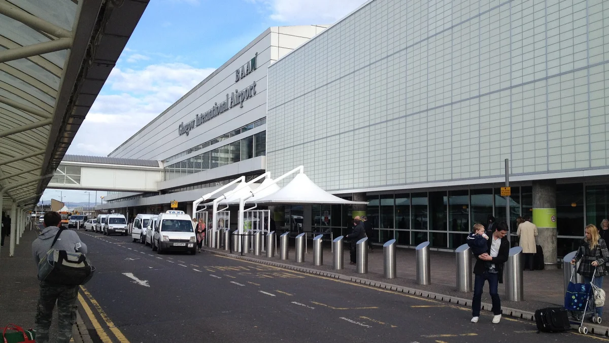 Cars and taxis at a UK airport terminal drop-off