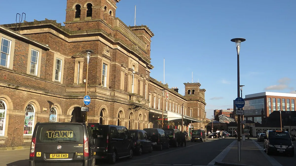 Taxis waiting outside Chester railway station. Photograph by Graham Robson, CC BY-SA 2.0.