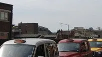 Black cabs lined up at the taxi rank outside London Waterloo station. The station name is not in the picture.