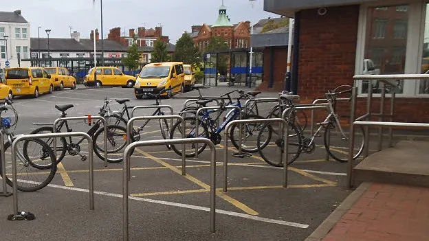 Yellow taxis outside Derby railway station. Photograph by Stephen Craven, CC BY-SA 2.0.