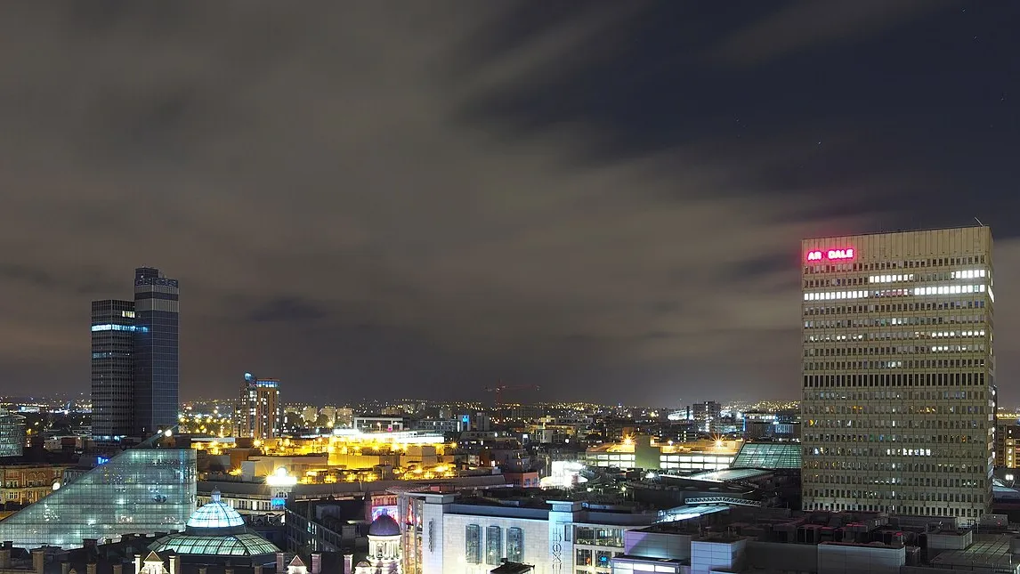 Manchester skyline at night, taken from the Renaissance Hotel. Photograph by Francis Franklin, CC BY-SA 4.0.