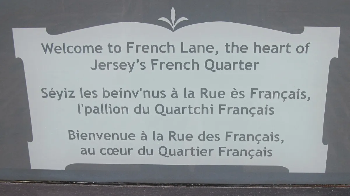 Welcome sign for Jersey's French Quarter on French Lane, Saint Helier. Photograph by Man vyi, public domain.