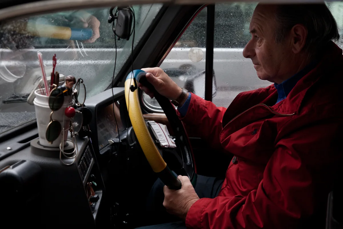 A London cabbie at the wheel of a black cab A London cabbie at the wheel of a black cab