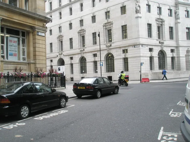 Knowledge student on a scooter with a map board at Finsbury Circus Knowledge student on a scooter with a map board at Finsbury Circus
