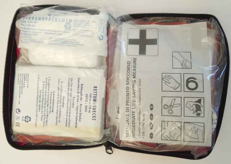Open first aid kit with dressings and medical supplies Open first aid kit with dressings and medical supplies