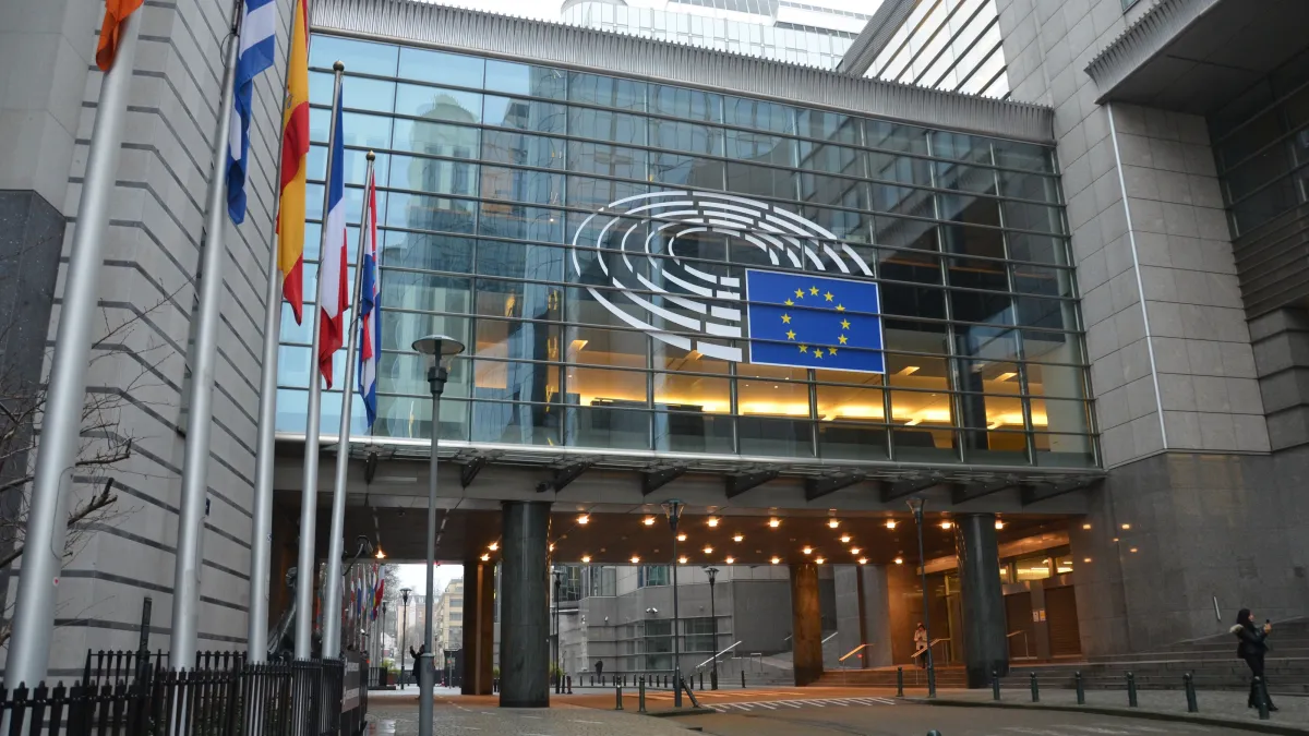 European Parliament building in Brussels with EU logo and national flags