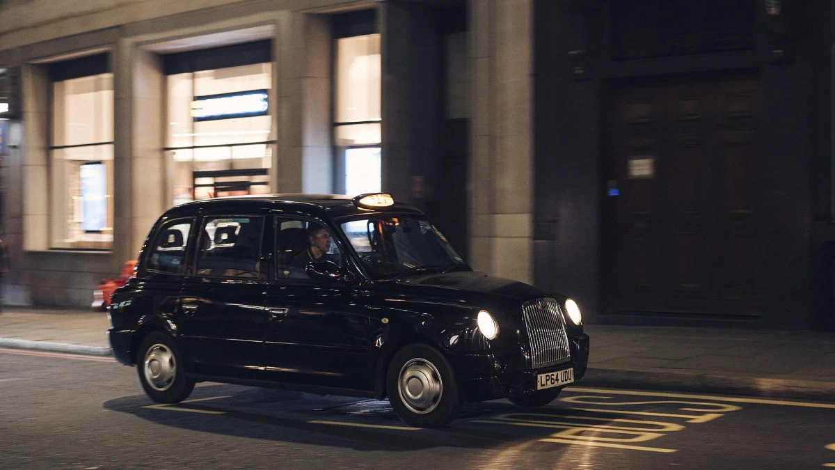 London black cab TX4 on a city street at night