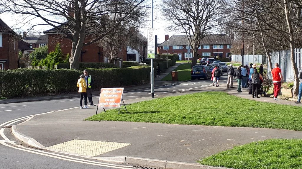 Parents and children at Hollybush Primary school gates, Leeds