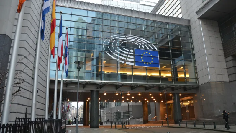 European Parliament building in Brussels with EU logo and national flags