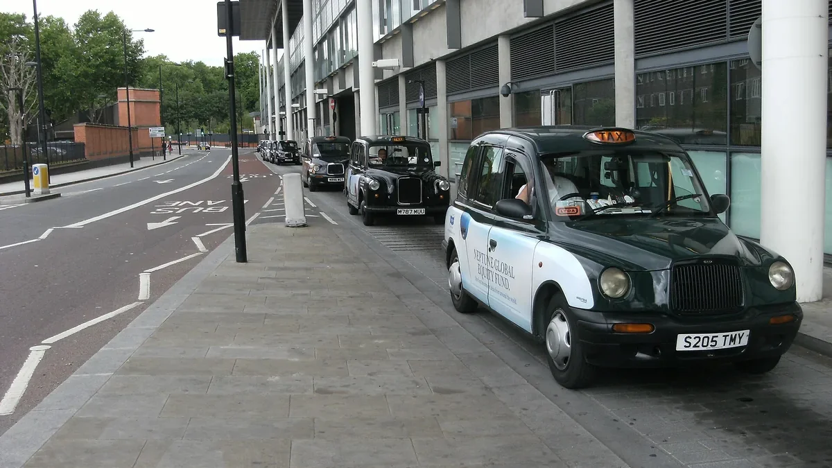 Black cabs waiting at a UK taxi rank
